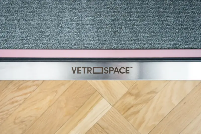 Close-up of a Vetrospace pod threshold with the VETROSPACE logo on a metal plate.